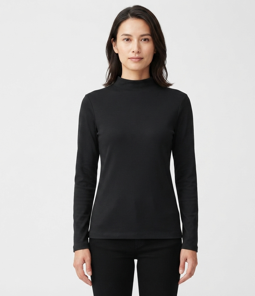 A woman modeling a black long-sleeve mock neck top against a plain light gray studio background.