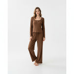A woman wearing a JOANNA FASHION brown ribbed long-sleeve lounge set with button-front top and wide-leg trousers.