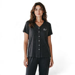 A woman wearing a JOANNA FASHION charcoal grey two-piece pajama set with a V-neck button-down top and matching pants.