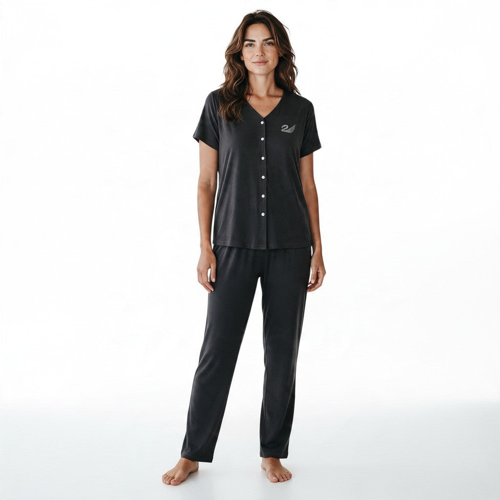 A woman wearing a JOANNA FASHION charcoal grey two-piece pajama set with a V-neck button-down top and matching pants.