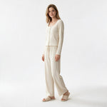A model wearing a JOANNA FASHION cream ribbed lounge set with a scoop neck top and wide-leg trousers on a white background