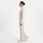 Model wearing JOANNA FASHION cream full zip track jacket and wide leg lounge pants in a side profile view.