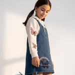 JOANNA FASHION girls' blue denim pinafore dress with white hoodie, featuring pink butterfly sleeves and graphic print.