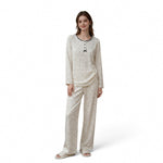 A woman wearing a JOANNA FASHION long sleeve pajama set in a cream floral print with button-down detail and trim.