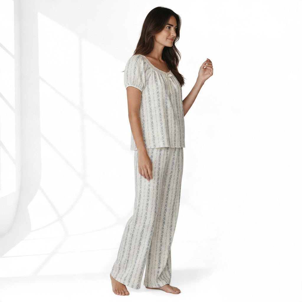 JOANNA FASHION floral print pajama set with puff sleeves, lace trim, and ribbon bow on a woman in a studio setting.