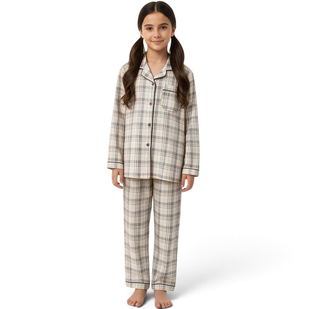 A young girl wearing a JOANNA FASHION neutral plaid button-down pajama set with long sleeves and contrast piping.