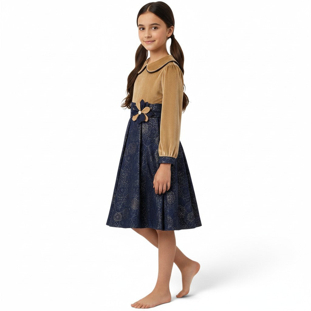 JOANNA FASHION girls' long sleeve velvet dress with a golden bodice, navy metallic skirt, and floral waist appliqué.