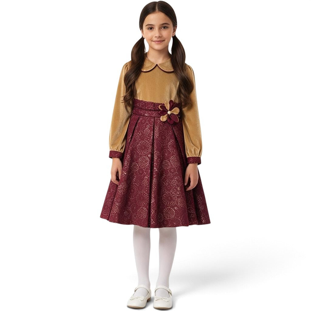 JOANNA FASHION girls' long sleeve velvet dress with a gold bodice, metallic burgundy skirt, and floral waist accent.