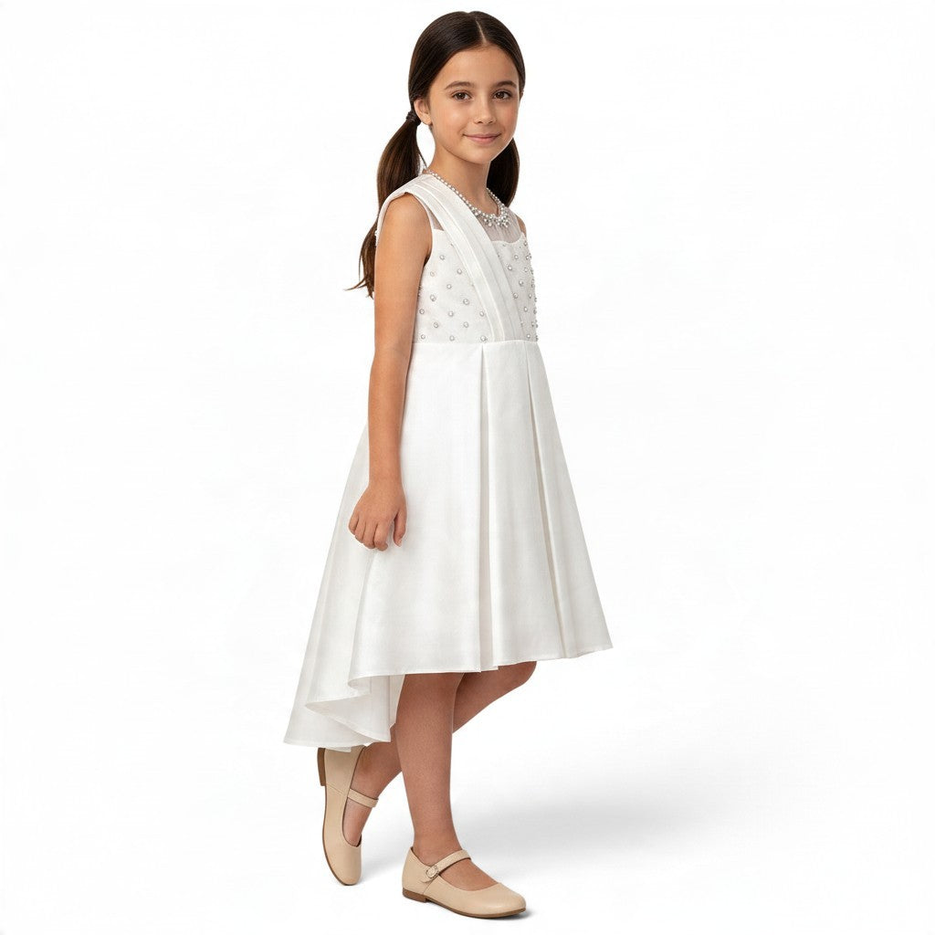 JOANNA FASHION girls' white formal dress with pearl-beaded bodice, illusion neckline, and high-low pleated skirt.