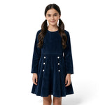 A girl wearing a JOANNA FASHION navy blue long sleeve corduroy dress with white button details at the waist.