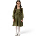 JOANNA FASHION girl wearing an olive green corduroy long sleeve pleated dress with a pearl butterfly waist accent.