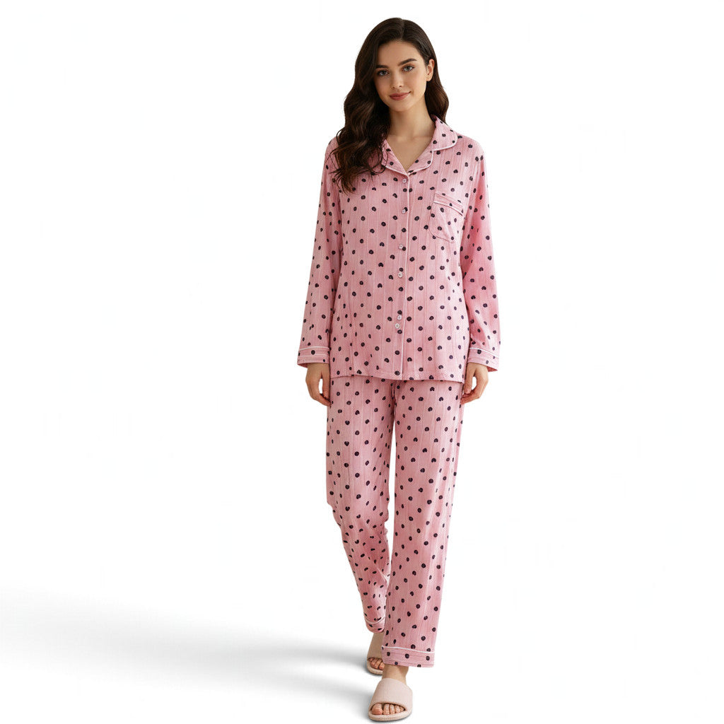 Model wearing a JOANNA FASHION pink long sleeve button down pajama set with a heart print and white piping details