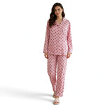 Model wearing a JOANNA FASHION pink long sleeve button down pajama set with a heart print and white piping details