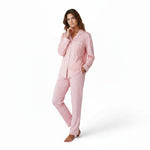 A woman wearing a JOANNA FASHION pink polka dot button-down pajama set with white contrast piping and notched collar.