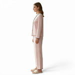 JOANNA FASHION pink polka-dot long sleeve button-down pajama set with scalloped trim worn by a woman in profile