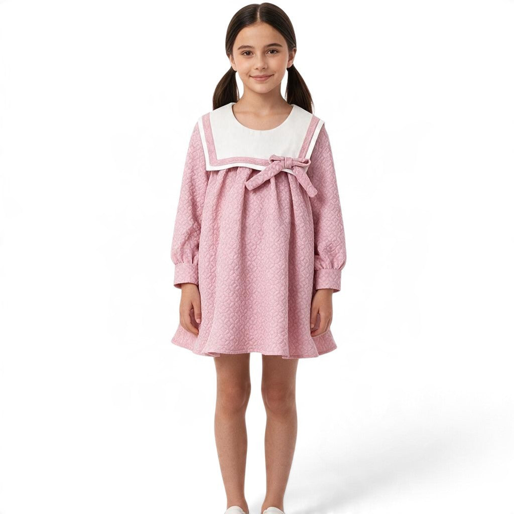JOANNA FASHION pink quilted long sleeve dress with a white sailor collar and bow detail worn by a young girl