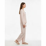JOANNA FASHION light pink long sleeve pajama set with star print, scoop neck, and black bow detail on a model