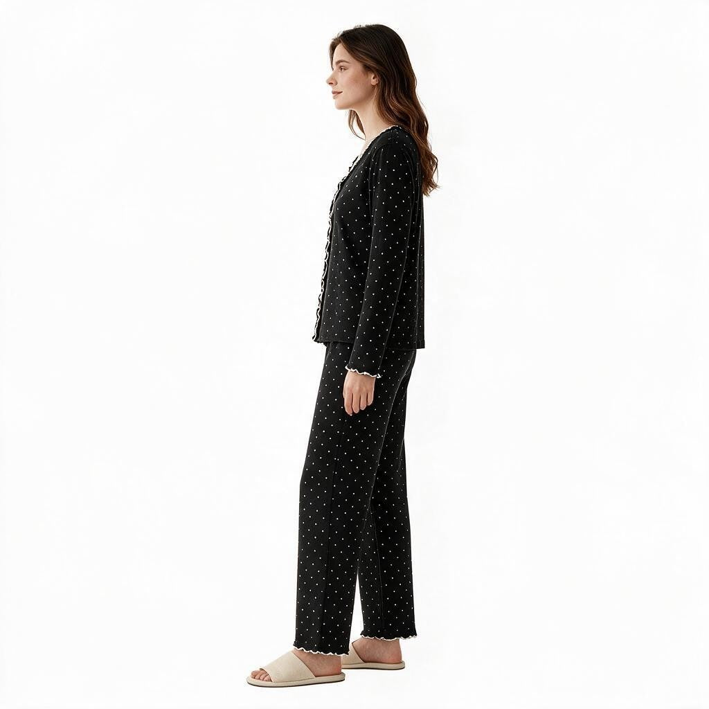 JOANNA FASHION black polka-dot long sleeve button-down pajama set with scalloped trim worn by a model, side view