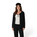 Model wearing a JOANNA FASHION three-piece black polka dot pajama set with a cherry tank top and matching headband.