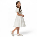 JOANNA FASHION white flower girl dress with rose-embellished bodice, puff sleeves, and glittery A-line skirt.