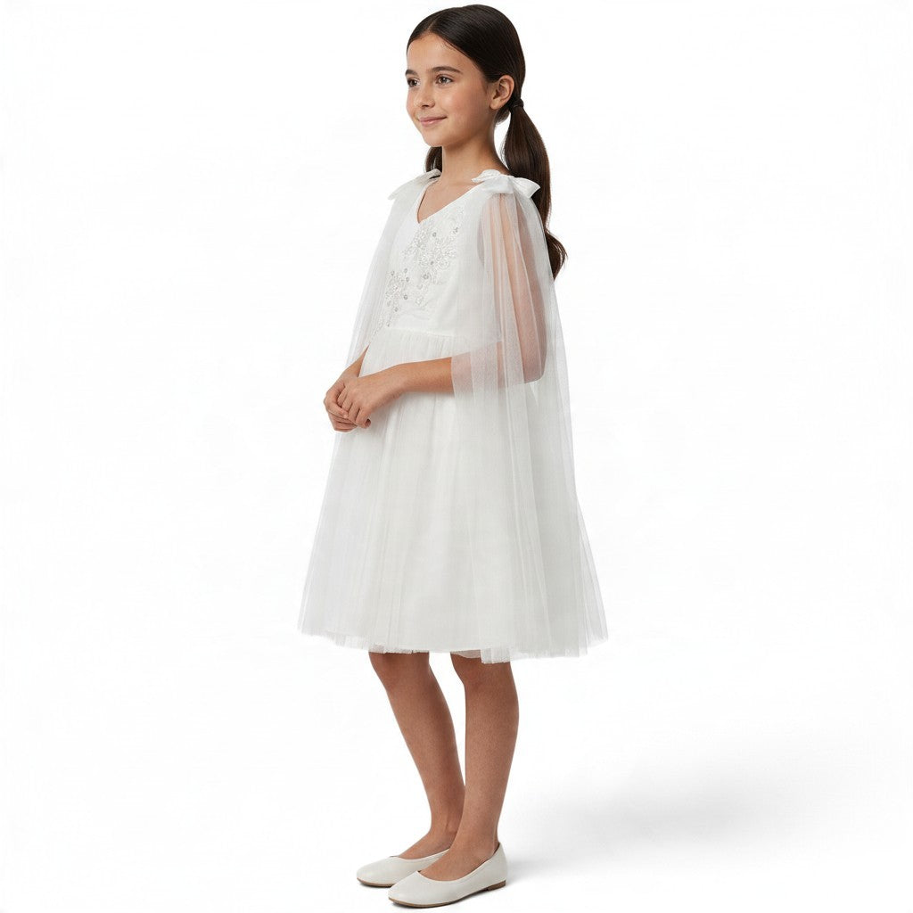 JOANNA FASHION white tulle special occasion dress with floral embroidery, beadwork, and an attached sheer cape.