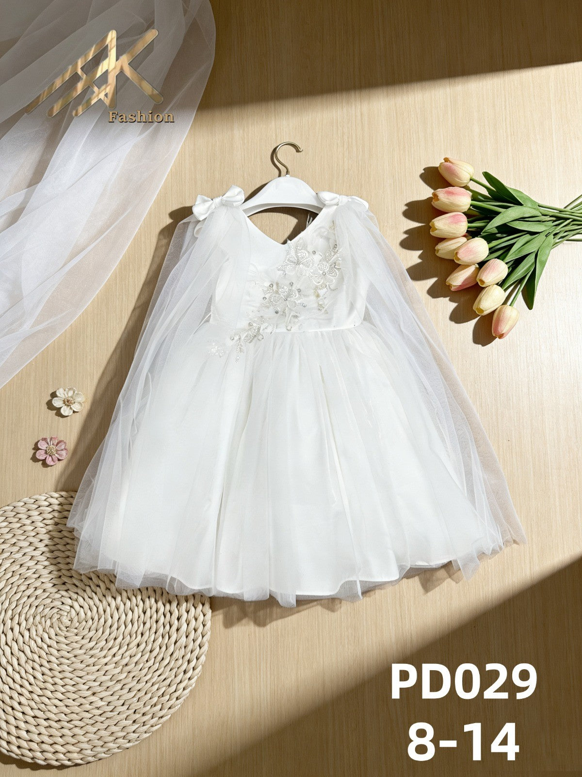 JOANNA FASHION white tulle special occasion dress with floral embroidery, beadwork, and an attached sheer cape.