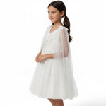 JOANNA FASHION white tulle special occasion dress with floral embroidery, beadwork, and an attached sheer cape.