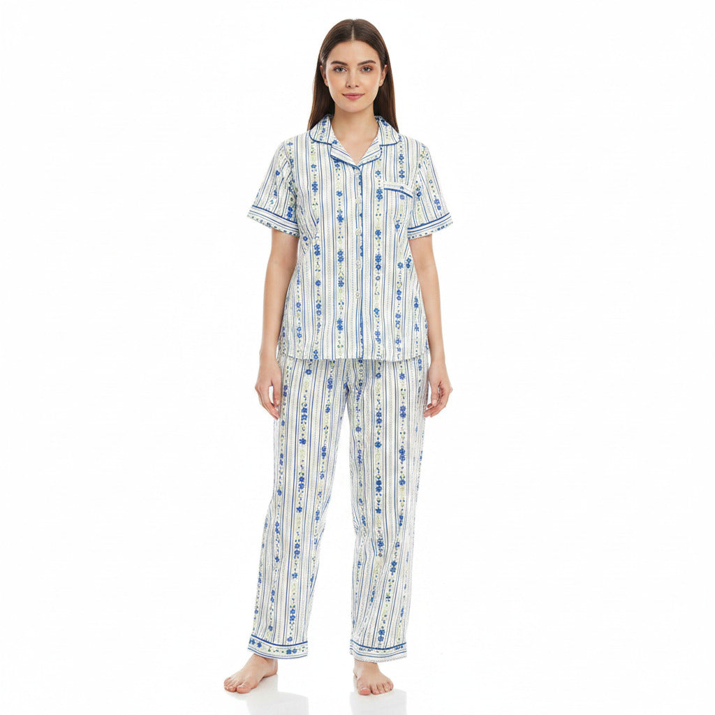 A woman modeling a matching short-sleeve pajama set with a white base and blue vertical patterned stripes, photographed against a plain white studio background.