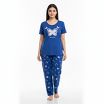 A woman modeling a blue two-piece pajama set with a butterfly graphic on the top and a matching butterfly print on the pants, set against a plain white background.