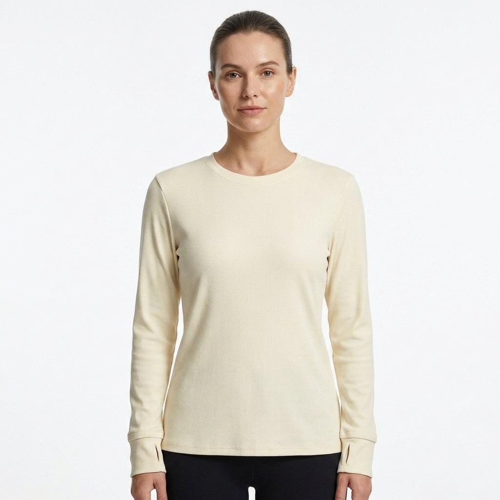 A woman modeling a light cream long-sleeve crewneck top against a plain white studio background.