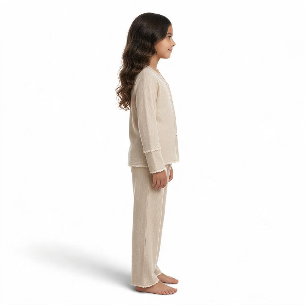 JOANNA FASHION girls beige long sleeve button-down pajama set with scalloped lace trim worn by a young girl