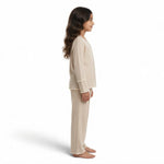 JOANNA FASHION girls beige long sleeve button-down pajama set with scalloped lace trim worn by a young girl