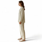 JOANNA FASHION model wearing a beige plaid button-down pajama set with long sleeves and matching relaxed trousers.