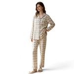 A woman wearing a JOANNA FASHION beige plaid button-down pajama set with long sleeves and matching relaxed trousers.