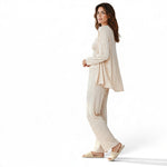 Model wearing a JOANNA FASHION three-piece beige ribbed loungewear set with cardigan, camisole, and wide-leg pants.