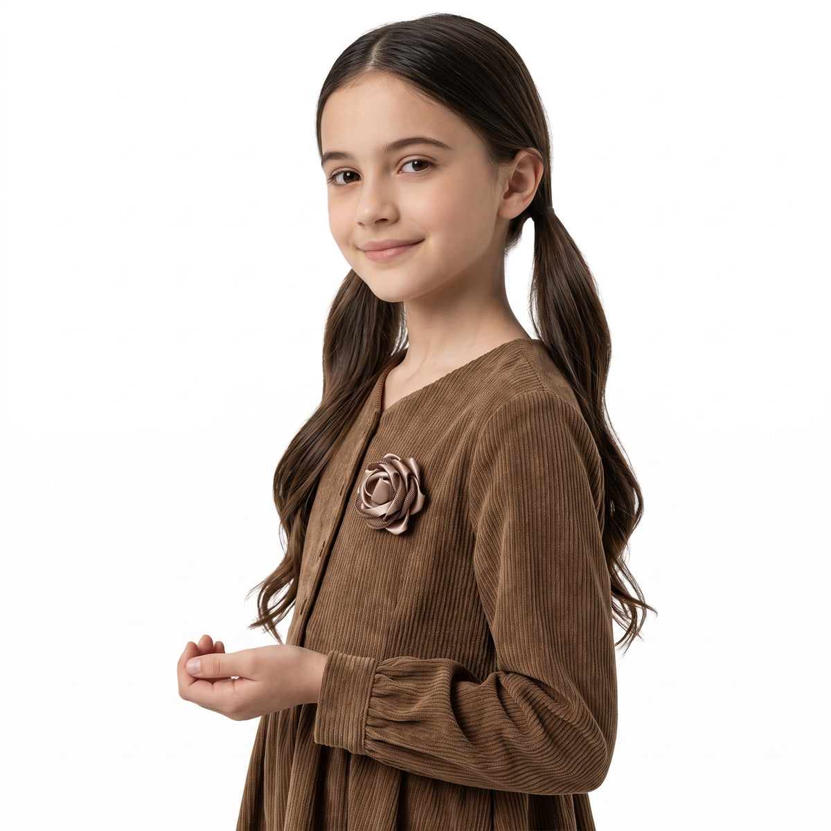 A young girl wearing a brown JOANNA FASHION corduroy dress with a rose floral appliqué on the chest.