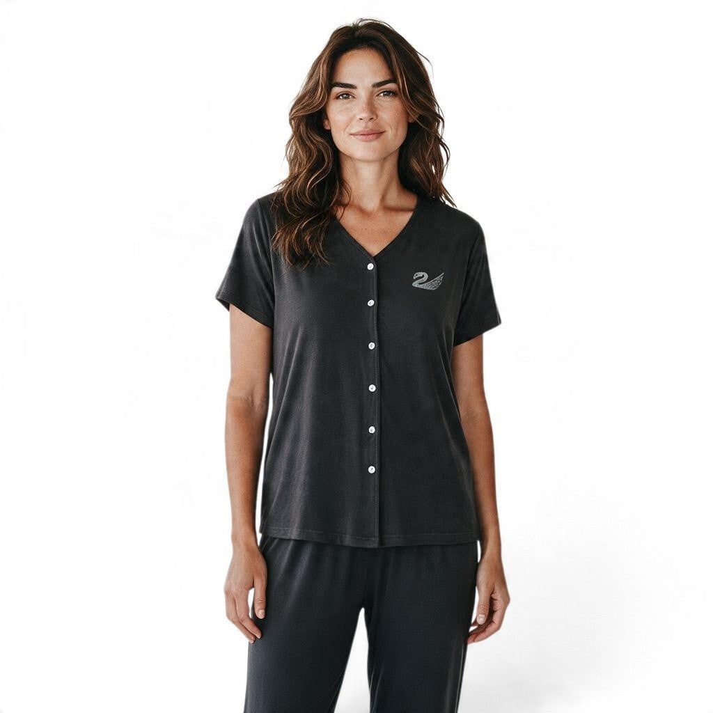 A woman wearing a JOANNA FASHION charcoal grey two-piece pajama set with a V-neck button-down top and matching pants.