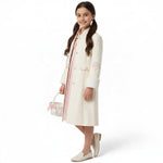 JOANNA FASHION cream long formal coat with floral sleeve embroidery and faux-fur cuffs worn by a young girl