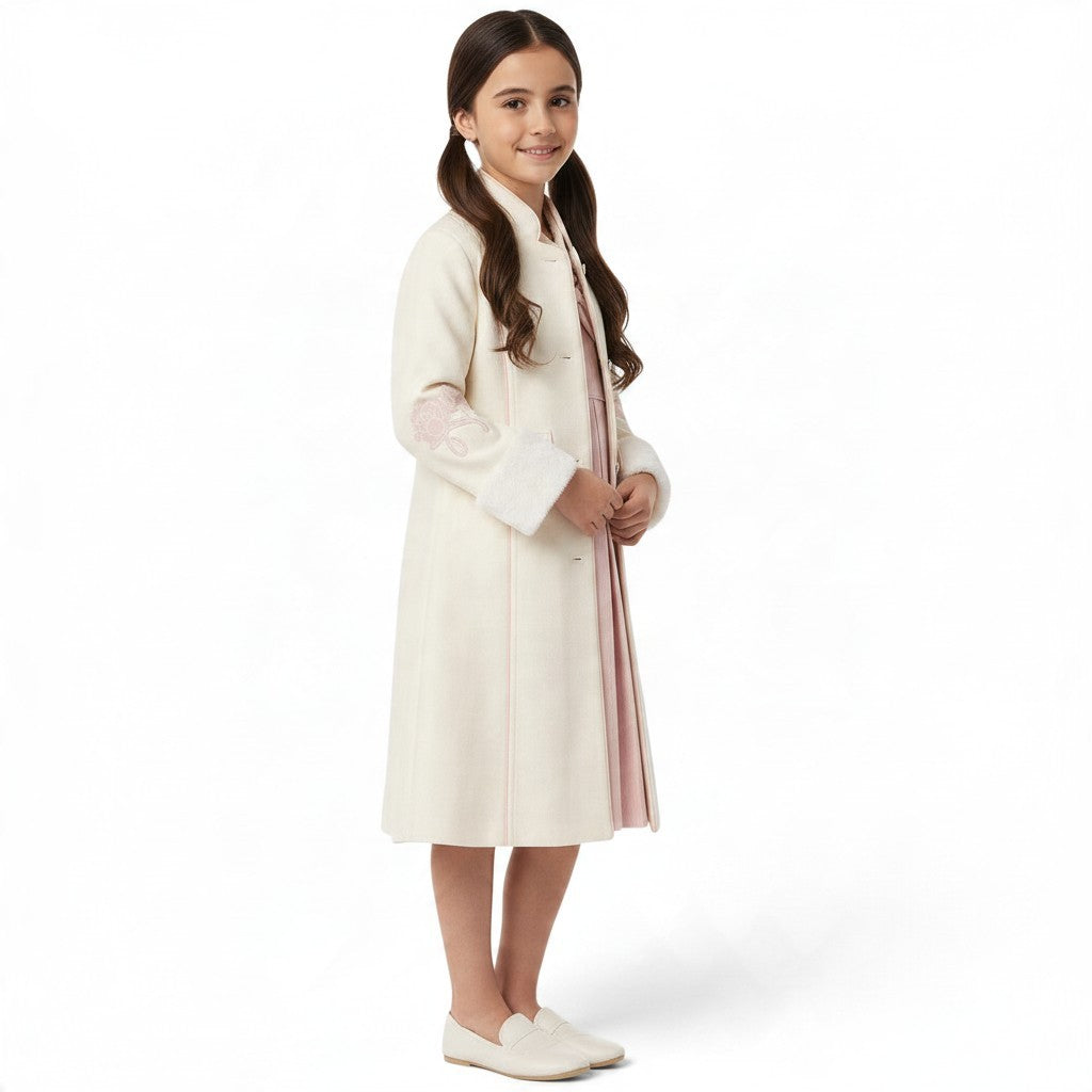 JOANNA FASHION cream long formal coat with floral sleeve embroidery and faux-fur cuffs worn by a young girl