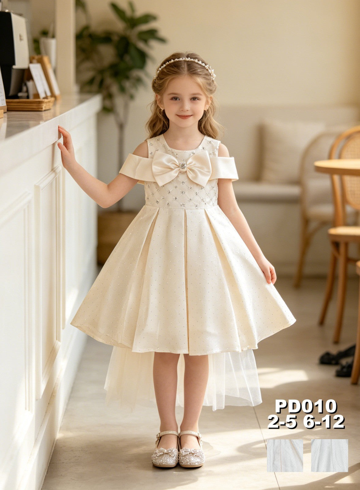JOANNA FASHION cream formal dress with off-shoulder sleeves, bow detail, and sparkling embellishments on a young girl
