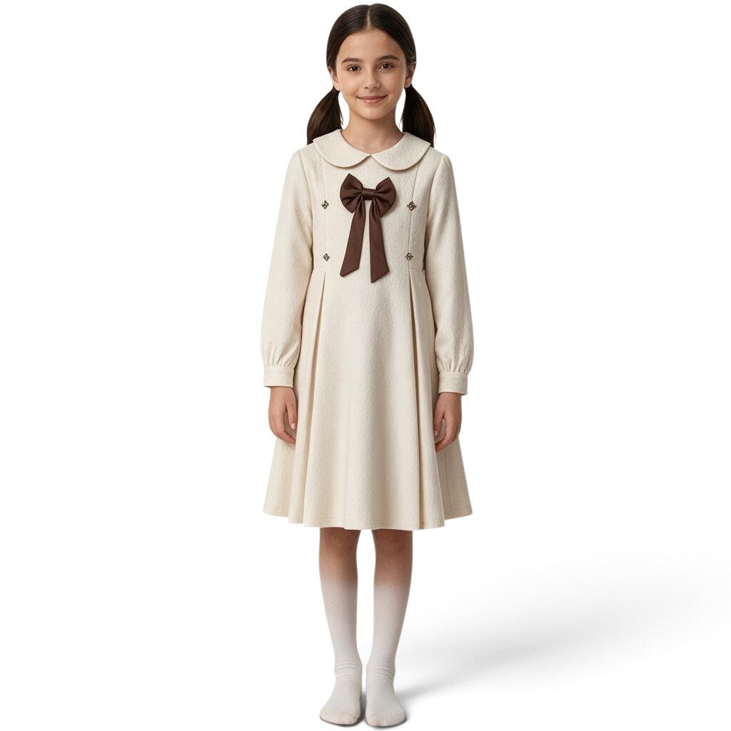 JOANNA FASHION cream long-sleeve dress with Peter Pan collar, brown bow, and pleated skirt on a young girl