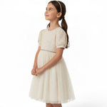JOANNA FASHION cream party dress with puff sleeves, embellished bodice, and tulle skirt worn by a young girl