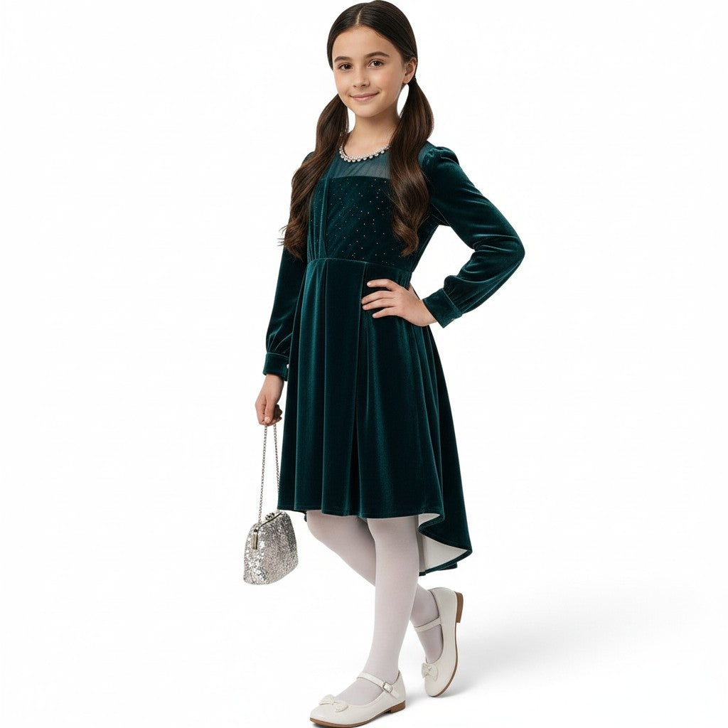 JOANNA FASHION girl in a deep emerald green velvet high-low dress with sparkling bodice and pearl-trimmed neckline.