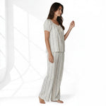 JOANNA FASHION floral print pajama set with puff sleeves, lace trim, and ribbon bow on a woman in a studio setting.