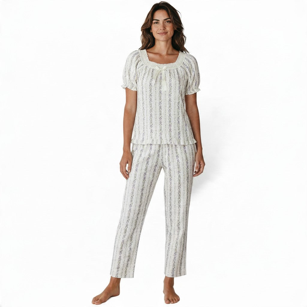 JOANNA FASHION floral print pajama set with puff sleeves, lace trim, and ribbon bow on a woman against white background