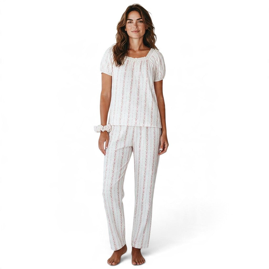 JOANNA FASHION floral print pajama set with puff sleeves, lace trim, and ribbon bow on a woman against white background