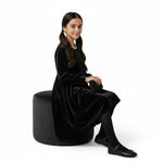 JOANNA FASHION girls black velvet high-low dress with pearl-like trim and long sleeves, worn by a young girl.