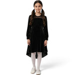 JOANNA FASHION girls black velvet high-low dress with sparkling bodice and sheer neckline worn with white tights