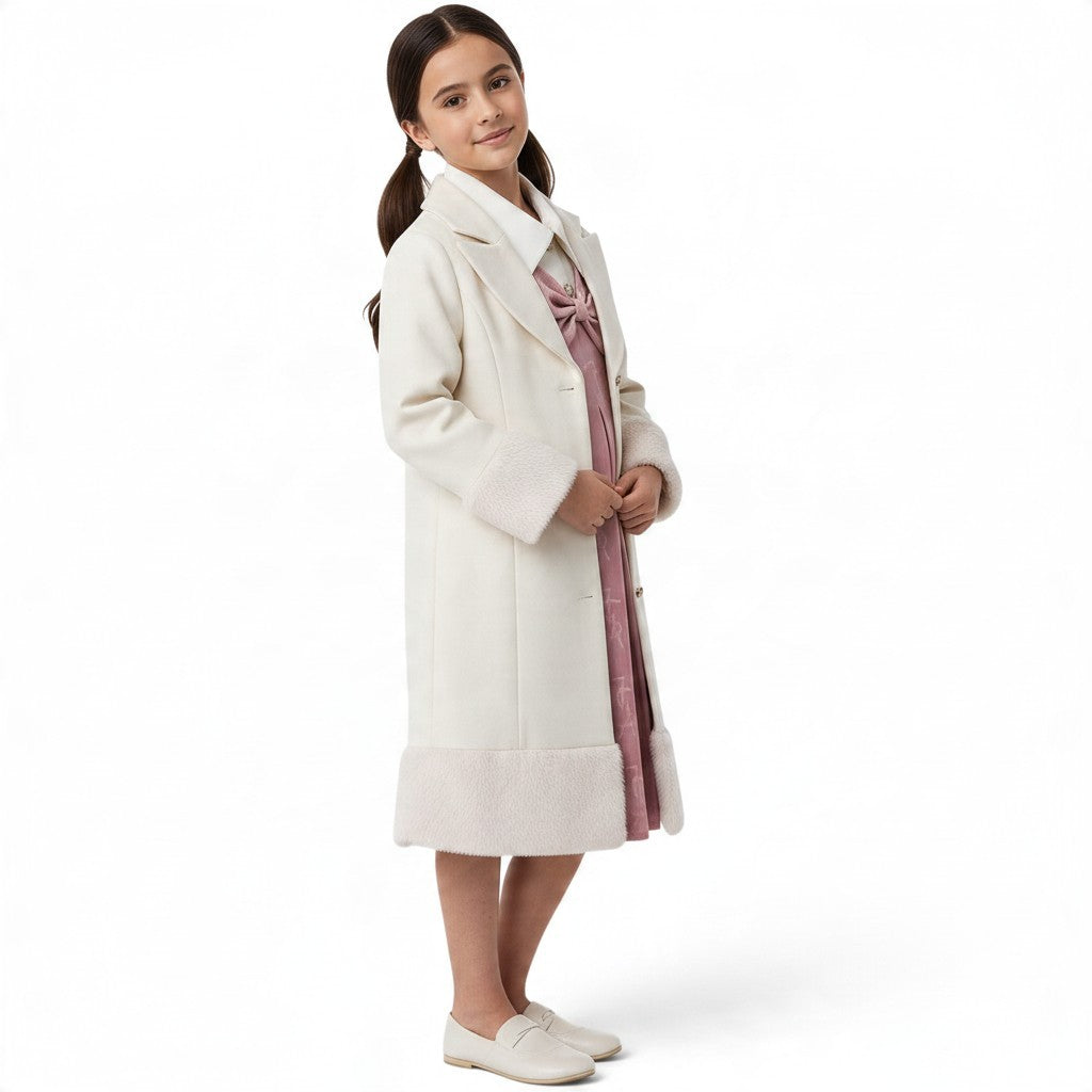 JOANNA FASHION cream wool-blend formal coat for girls with faux-fur cuffs and hem, worn over a pink dress.