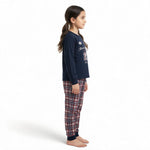 JOANNA FASHION girls long sleeve pajama set with navy graphic top and plaid bottoms, side view on a young girl.
